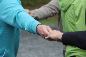 Close-up of hands holding others during the Black Out