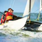participants sailing catamarans during the Beach & Water Olympics