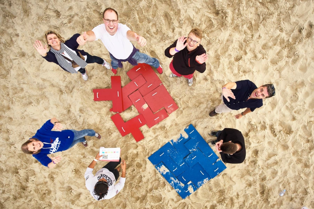 puzzle: aerial view of participants doing puzzles during the Beach Olympics