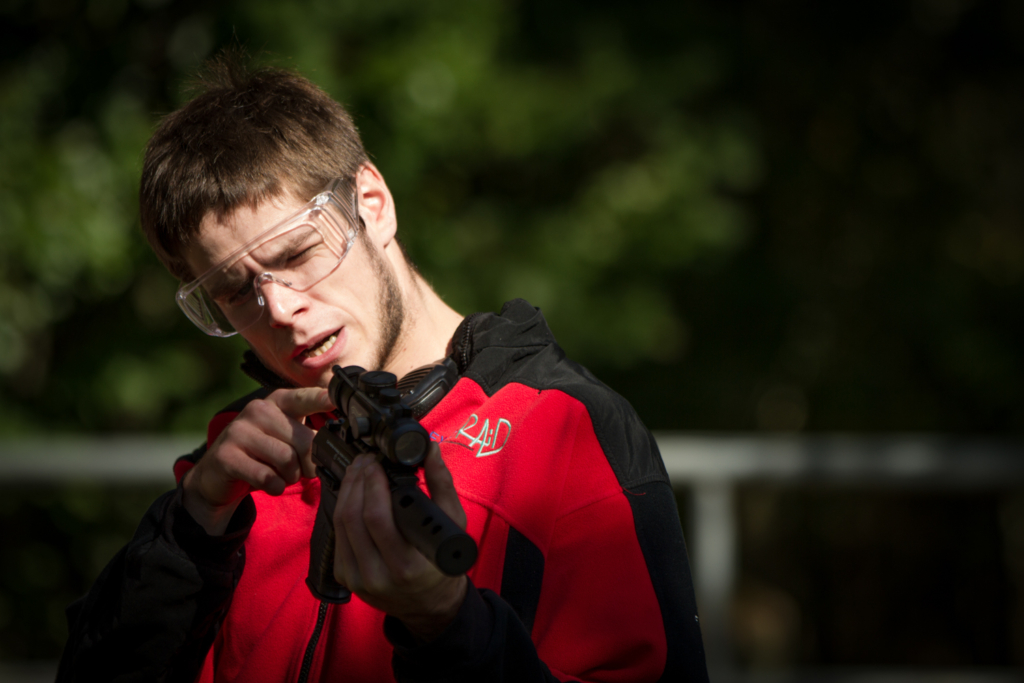 participant aiming and firing an air pistol during Castle Investigation