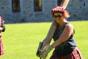 participant carrying a trunk during the highland games