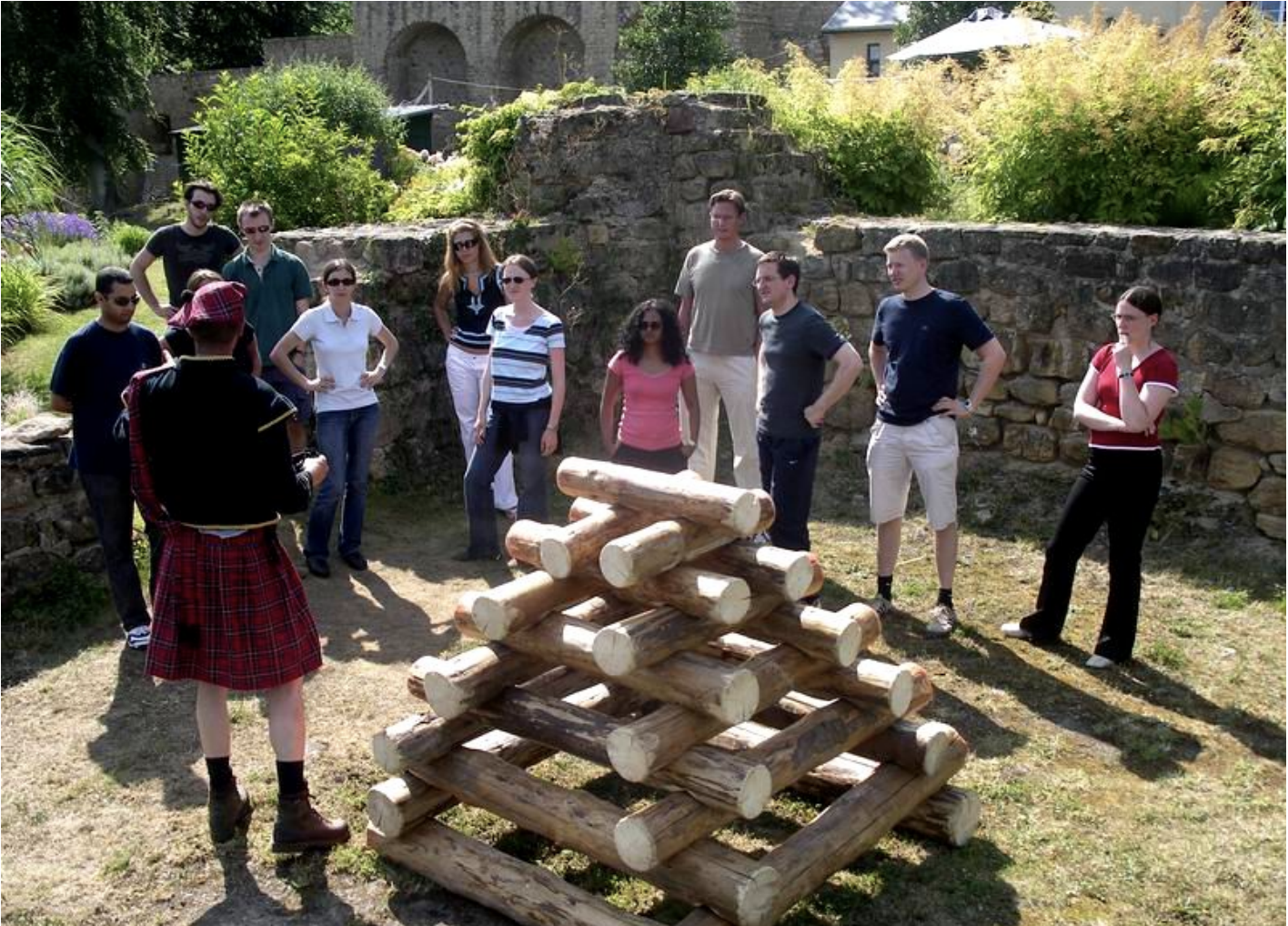 team facing a pyramid of logs during Highland Games