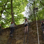 participants climbing a natural wall during the Lost