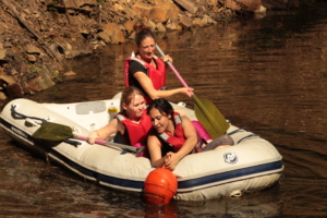 participants in an inflatable boat on the water during the Lost