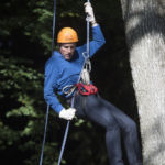 participant in a zip line descent during an aerial course