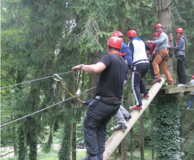 team climbing in the trees during a boar game
